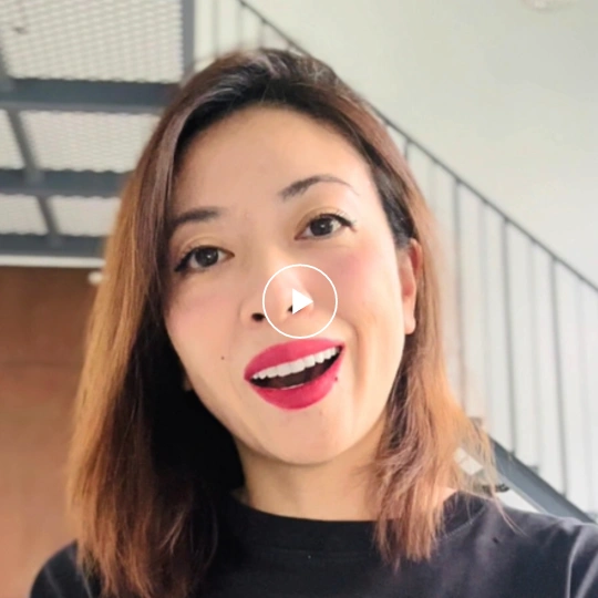 The founder, a woman in her 30s, showing warmth and kindness with a friendly expression.